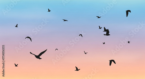 A flock of birds is flying in the sky at sunset, creating a beautiful and serene scene with a gradient of colors in the background
