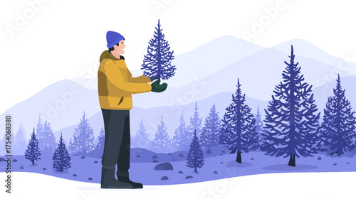 Man in winter coat holds a small evergreen tree in a snowy mountain forest