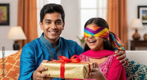 happy indian man giving gift box to sister on diwali festival