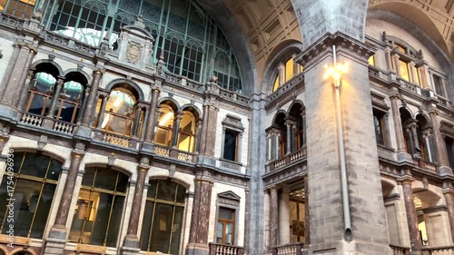 Antwerp Central Station ornate architecture with glass roof, clock tower, travel destination in Belgium