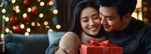 Lovely couple with gift box at home room in holiday season