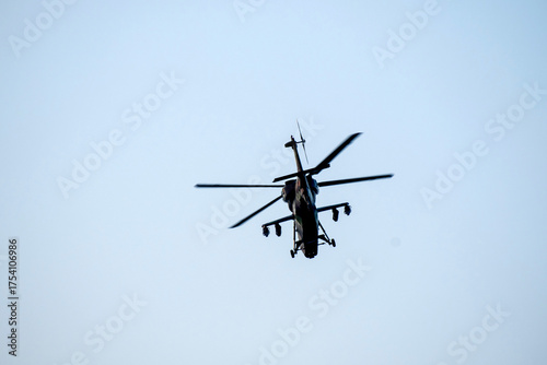 Helicopter is flying over isolated blue sky 