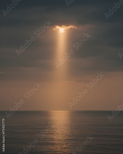 Sunlight Breaking Through Clouds Over Calm Sea