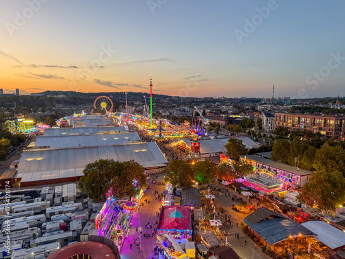 Birds eye view of carnival rides and festival crowd in stuttgart germany