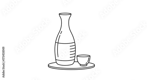 A traditional Japanese sake bottle with a small cup on a tray.