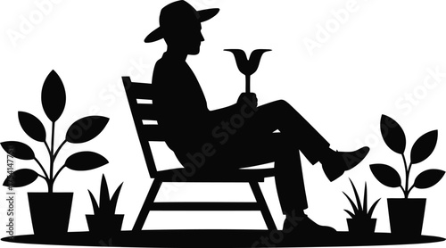 Man sitting in a garden holding a tulip enjoying nature silhouette
