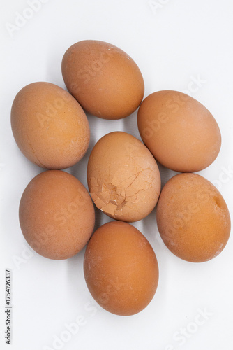 six eggs are laid in a circle with one broken egg in the middle