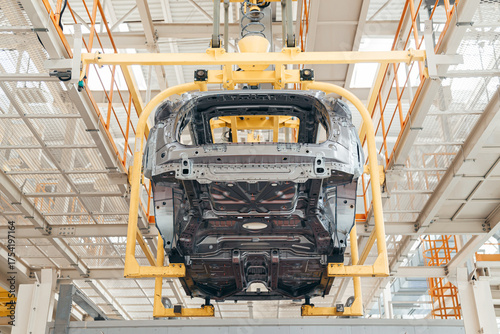 Automotive industry assembling conveyor line, car body suspended with bracket.