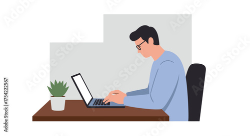 A man wearing glasses sits at a desk, typing on a laptop with a potted plant beside him, suggesting focused work or study.