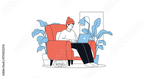 A person wearing a beanie and sitting in a comfortable armchair while using a laptop.