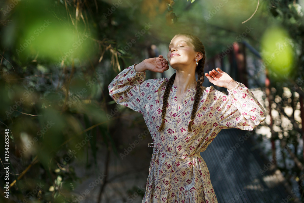 © Westend61 - Smiling woman standing with eyes closed near trees © Westend61 - Smiling woman standing with eyes closed near trees