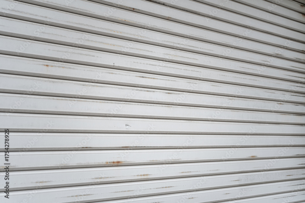 Obraz premium Metal grate rolling door of the warehouse storage or service garage.