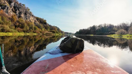 Experience a serene paddleboarding adventure on a calm river, perfect for nature lovers and outdoor enthusiasts seeking tranquility and excitement during summertime recreational activities