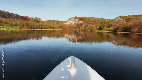 Immerse yourself in a truly serene kayaking adventure as you glide through the stunningly vibrant autumn colors, all while enjoying the peaceful moments of reflection on the calm lake waters