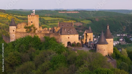 bourscheid castle château de green cover hills farms beautiful homes sunny day train leaving town adds detail reveal around pull dynamic circling drone back 