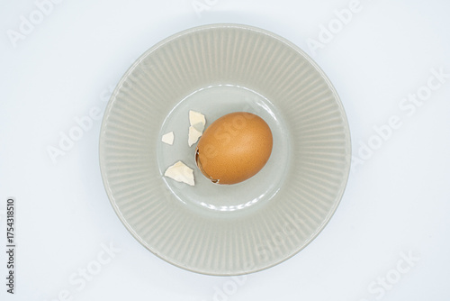 Boiled eggs in a circular bowl on a white background