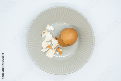 Boiled eggs in a circular bowl on a white background