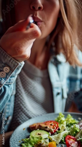 cropped woman eating vegetable salad with fork