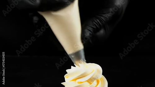 Pastry Chef Decorating Dessert With Yellow Buttercream Frosting Close Up
