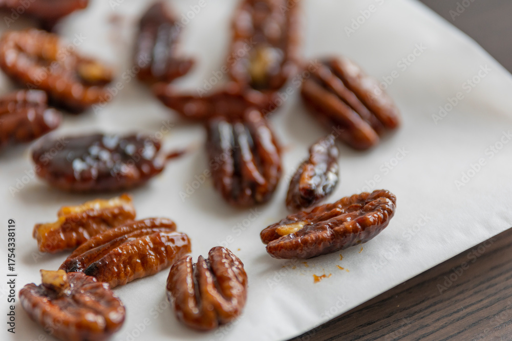 Obraz premium caramelized pecans on white background close up