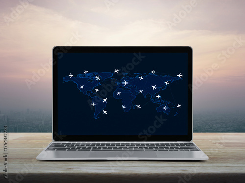 Fototapeta Naklejka Na Ścianę i Meble -  Flight routes airplanes connection and world map on laptop screen on table over city tower at sunset sky, vintage style, Airplane transportation network, Elements of this image furnished by NASA