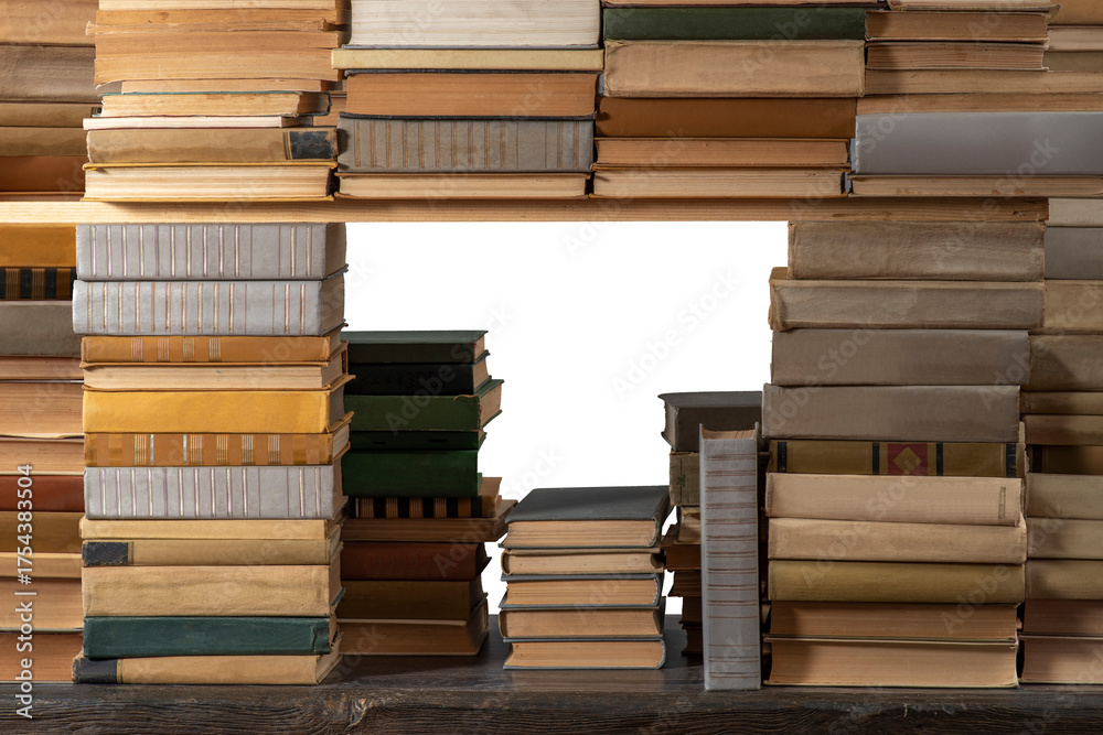 Obraz premium Stacks of many books on a shelf or table on an isolated background. Concept of library, reading, old classic literature