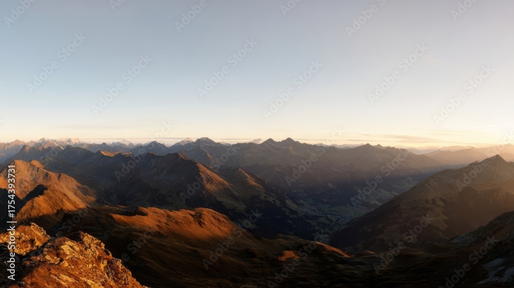 Naklejka premium Dramatic mountain panorama bathed in golden sunset light,