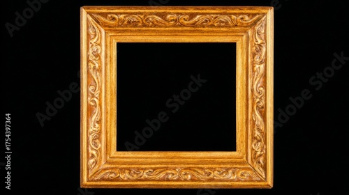 A golden ornate square picture frame with intricate baroque detailing stands elegantly against a black background,