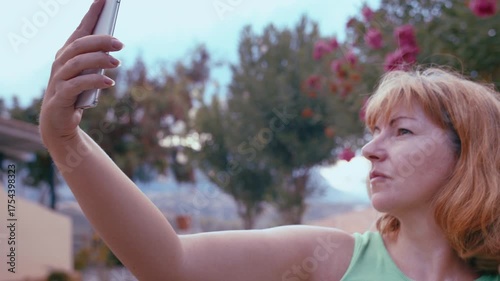 Woman Taking Selfie with Smartphone Outdoors in Nature Landscape