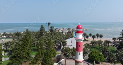 Aerial drone shot, flying over the streets of Swakopmund and the historic Swakopmund Lighthouse in Namibia.	
