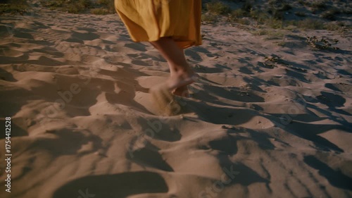 Weary Young Female Struggling to Walk Through Barren Sandy Environment Under Heat, legs close-up