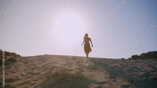 Tired Woman in Isolation Walking Alone on Dry Desert Sandscape