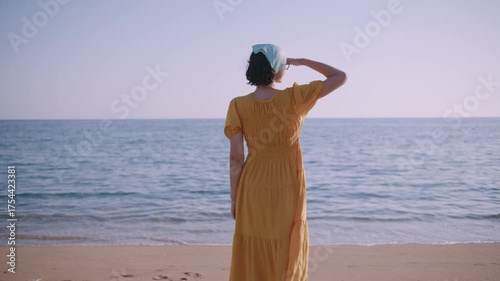 Woman Standing on Seaside Shoreline and Gazing into Vast Ocean Horizon