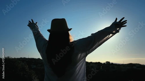 Cityscape at Dawn: Woman Embracing the Majestic Sunrise View from a Mountain Overlooking the City