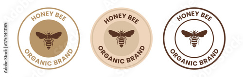100% Natural wild raw organic honey logo label concept with bee symbol inside hexagon honeycomb nectar drop sign. Beekeeper farm badge brand identity template. Vector illustration.
