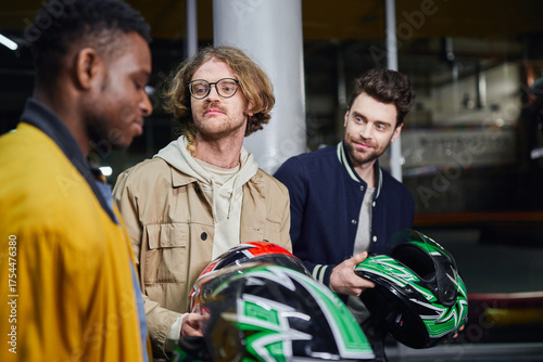 Fotografía Friends gear up for a thrilling day of carting and leisure activities indoors in