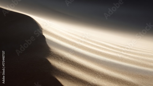Fototapeta Naklejka Na Ścianę i Meble -  A sand dune with clean, flowing lines created by the wind.