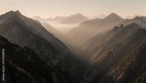 Hazy mountain range with a valley below bathed in golden light, creating a serene scene