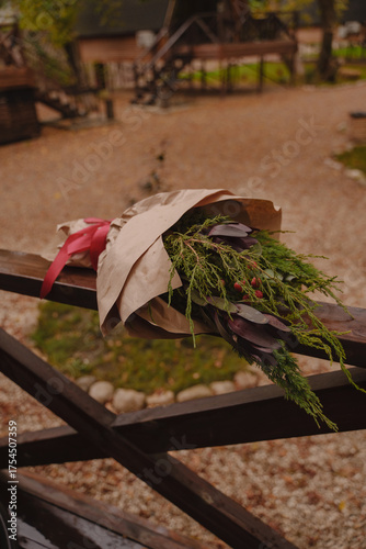 A Christmas bouquet is lying on a wooden fence. Interior bouquet of coniferous branches.