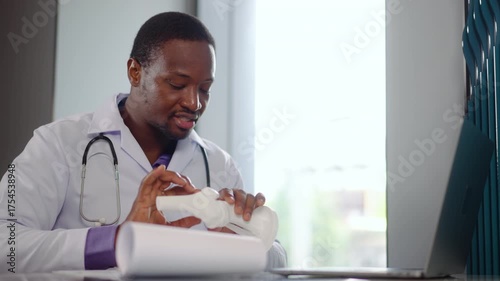 African male doctor conducts a telemedicine online webcam video call session with a patient, demonstrating the importance of remote healthcare. The conversation emphasizes accessibility and care.