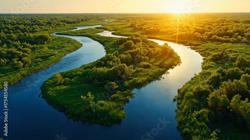 Sunset's warm reflection on the river or lake's water creates a beautiful nature landscape with trees and clouds in the sky