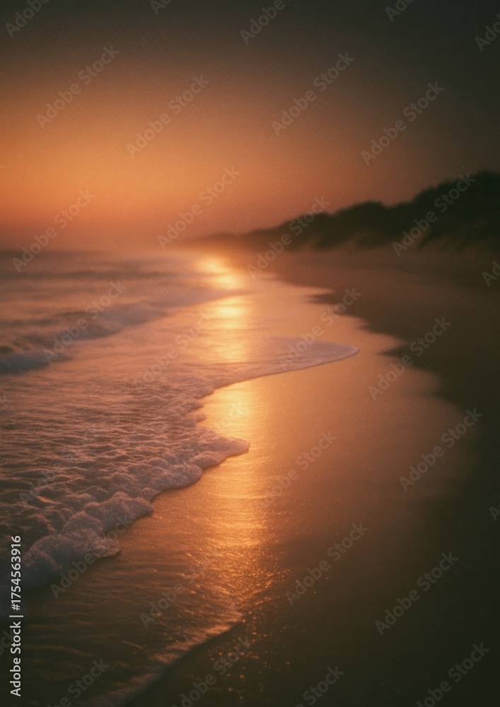 Fototapeta premium Serene beach sunset with golden hues reflecting on gentle waves