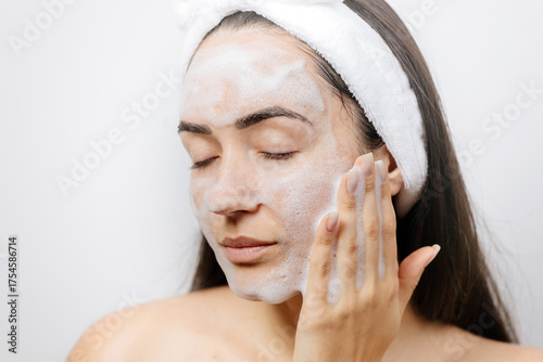 woman washing face foam. female applying Facial Cleanser. Young adult woman using foam cleanser for face skin cleaning. 