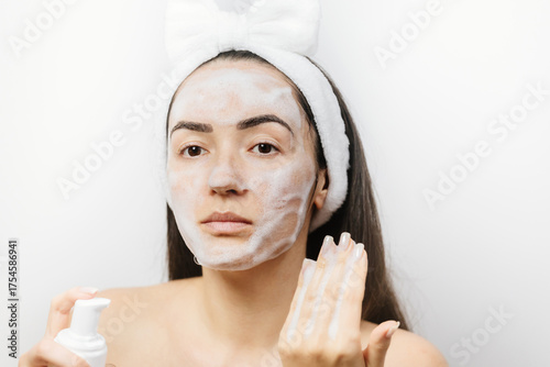 woman applying Facial Cleanser. Young adult woman using foam cleanser for face skin cleaning. 