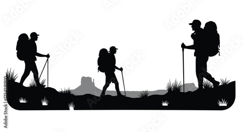 Silhouette of three hikers walking with poles on a mountain trail