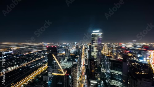 Wallpaper Mural A night cityscape showcasing modern architecture. Blurry light trails from traffic streak through the frame, with tall buildings Torontodigital.ca