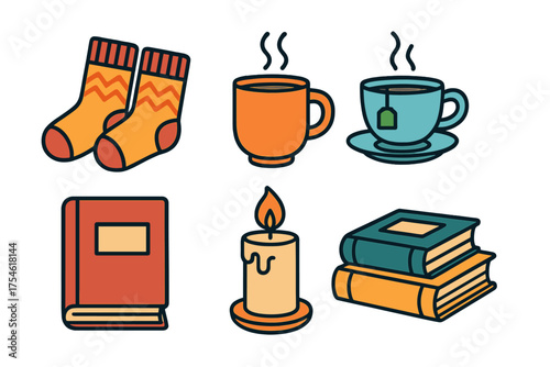 Cozy autumn and winter elements including warm socks hot drinks books and a burning candle