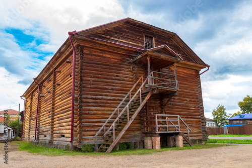 Exterior view of the historic wooden two-story log barn with stairs. Built in 19th century at Yeniseysk in Krasnoyarsk krai, Russia.