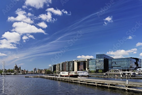 Booking com headquarters, at the back Basilica of St Nicholas (Dutch: Sint-Nicolaasbasiliek), Roman Catholic church with neo-baroque and neo-renaissance elements, Amsterdam, province of North Holland, Netherlands