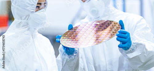 Bild auf Leinwand 半導体工場でシリコンウエハーを検査する防塵服を着た男性作業員